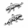 Zinc alloy pendant in the shape of a tiger with size of 22 x 11 x 2,5 mm and with a 1.5 mm eyelet for the stringing material. The pendants are made of zinc alloy, which is commonly referred to as jewellery metal.
THE PRICE IS FOR 1 PIECE.